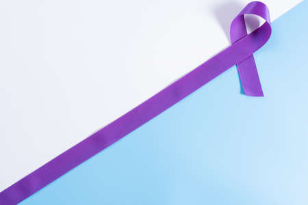 World cancer day, purple ribbon on with and blue background with copy space for text. Healthcare and medical concept.の写真素材