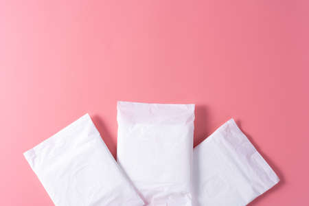 Sanitary pad, Sanitary napkin on pink background. Menstruation, Feminine hygiene, top view.の写真素材