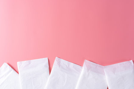 Sanitary pad, Sanitary napkin on pink background. Menstruation, Feminine hygiene, top view.