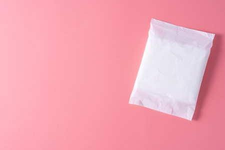 Sanitary pad, Sanitary napkin on pink background. Menstruation, Feminine hygiene, top view.の写真素材