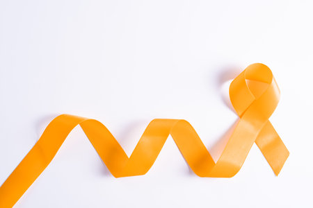 World kidney day, orange ribbon awareness of kidney disease isolated white background.
