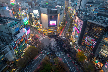 A travel landscape shows people crossing a busy street at dusk.の素材
