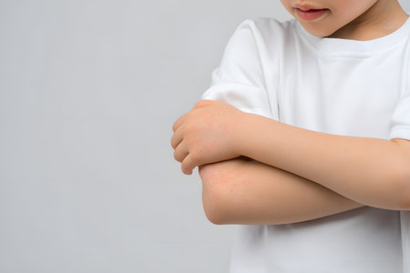 Child shows arm pain due to rash.の素材