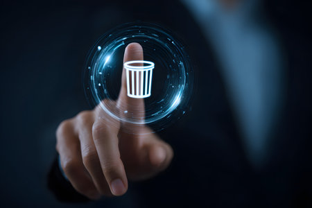 A finger touches a digital trash can icon to delete data.の素材