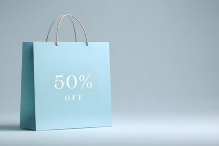 A blue shopping bag displays a fifty percent off sale.の素材