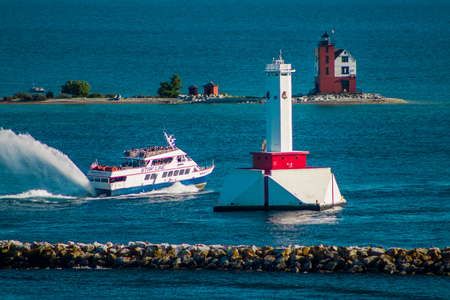 Star line ferry passing the two lighthouses on Mackinac Island Michiganのeditorial素材