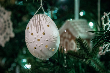 blown out egg ornament on a decorated christmas tree around the holidays