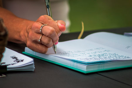 Guest signing a wedding guest book