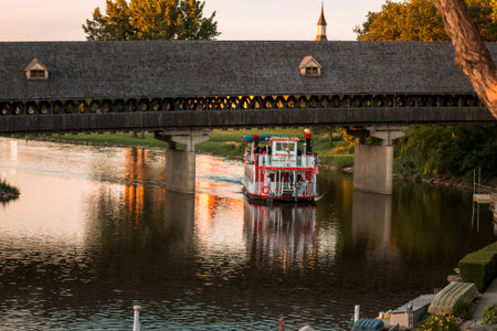Bavarian Belle ferry going under a covered bridge in Frakenmuth Michiganのeditorial素材