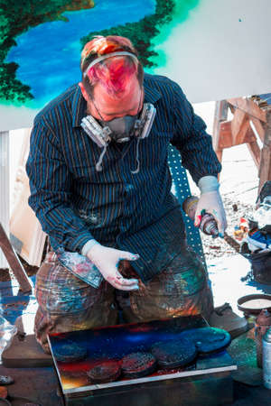 Spray paint artist showing off his craft at Artprize 9 in Grand Rapids Michiganのeditorial素材