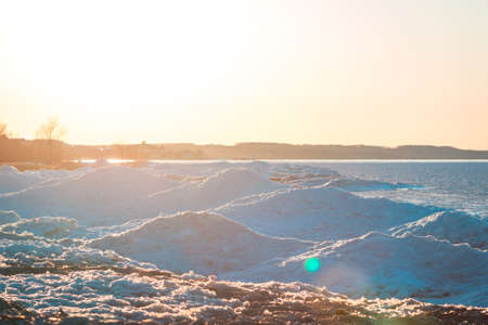 Ice dunes in Petoskey Michigan during the winter at sunsetの写真素材