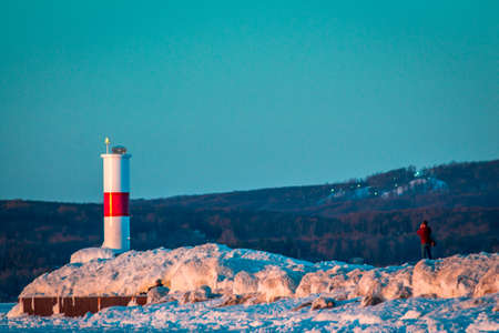 Photographer taking photos of the light house in Petoskey Michigan in winterの写真素材