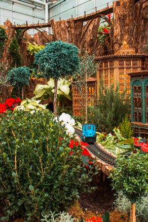 Blue model train traveling through a model city  at the Frederik Meijer Gardensのeditorial素材
