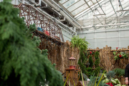 Model train traveling through display in a greenhouseのeditorial素材