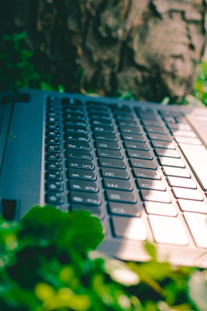 Macro shot of a laptop computer keyboard infront of a logの写真素材
