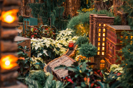 Red train zipping through the holiday horticultural train display city in the gardens in Grand Rapids Michiganのeditorial素材