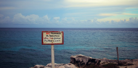 Spanish sign that reads:  Do Not Approach the Cliff