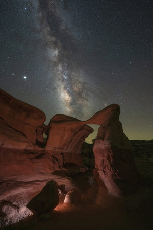 Light painted Metate Arch under the Milky Way Galaxy in Escalante Utah