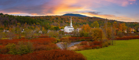 Colorful panorama of Stowe Church and the fall foliage in Vermont