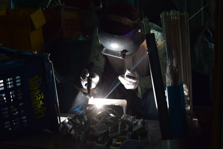 welder at work in the factory, close-up of photo
