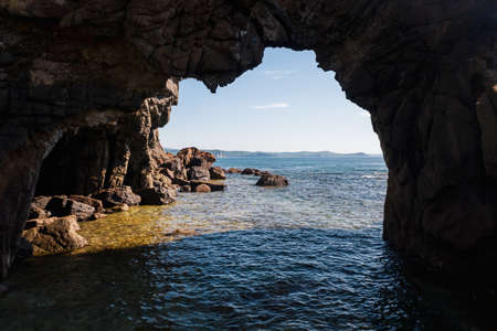 View of the arch made of natural stone by the seaの写真素材