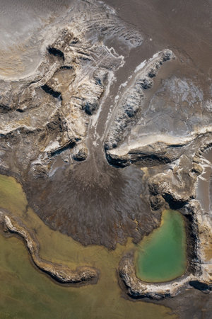 Drone view of the turquoise lake formed as a result of mining waste