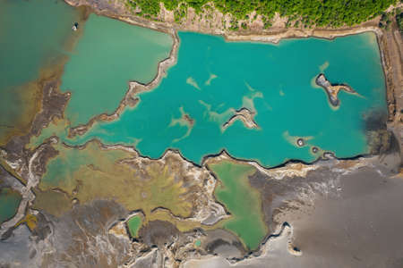 Drone view of the turquoise lake formed as a result of mining wasteの写真素材