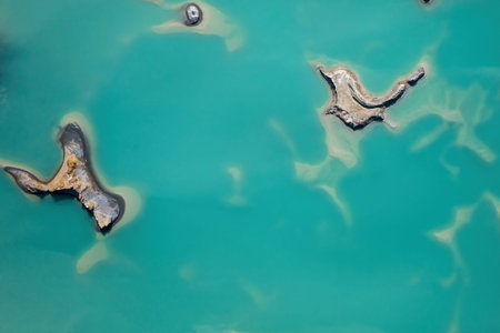 Drone view of the turquoise lake formed as a result of mining waste
