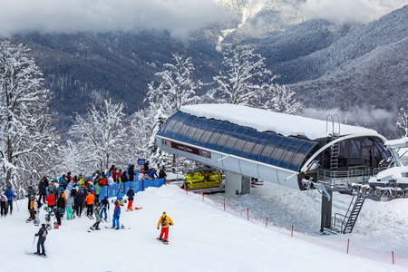 The queue for boarding the ski lift at the Rosa Khutor resort on a sunny dayのeditorial素材
