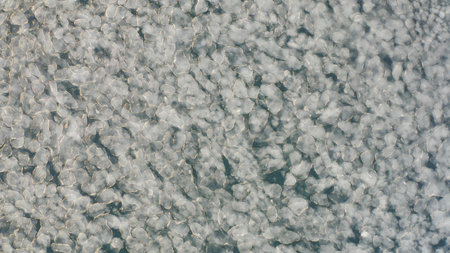 Glacial lagoon with ice floes on top. Birds-eye. Moving cracked ice