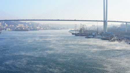 The surface of the sea under the cable-stayed bridge soars on a cold winter dayの写真素材