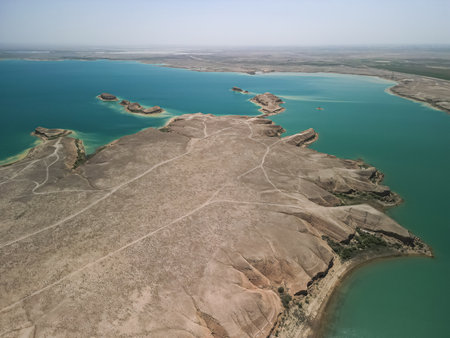 Aerial view of arid headland and intricate water shapes in reservoir Uzbekistanの写真素材