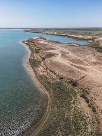 Kuimazar Reservoir shoreline landscape in Uzbekistan with blue waterの写真素材
