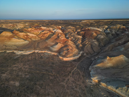 Evening light over Aktumsik headland and surreal desert escarpments, Uzbekistanの写真素材