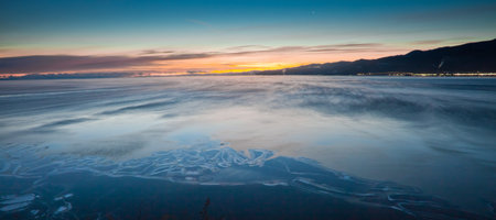 Dark blue waters of lake baikal and blue predawn sky
