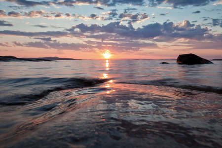 thick water at sunset in karelia scandinaviaの写真素材