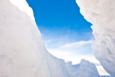 view of the blue sky from an ice crack in the hummocks on Lake Baikal