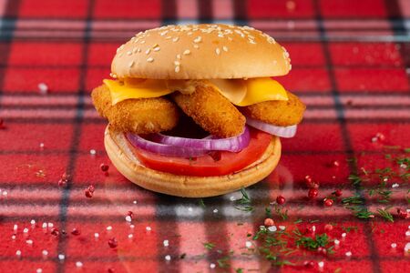 burger with chicken nuggets fresh vegetables and cheeseの写真素材