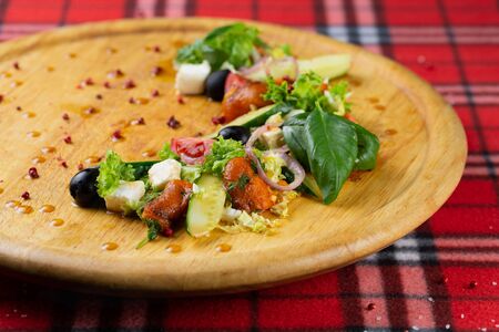 Vegetarian salad of pickled vegetables and cheese. Greek satate with pepper, cucumber, cheese, olives and lettuce seasoned with olive oilの写真素材