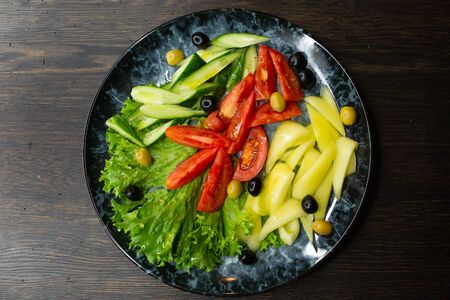 assorted fresh vegetables, tomato, cucumber, pepper, lettuce, olivesの写真素材