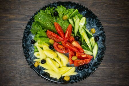assorted fresh vegetables, tomato, cucumber, pepper, lettuce, olivesの写真素材