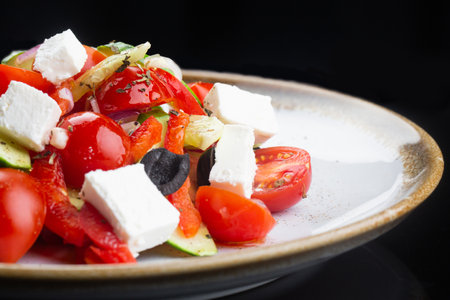 Greek salad with all cherry tomatoes, cucumber and lettuce and feta cheese, seasoned with olive oilの写真素材