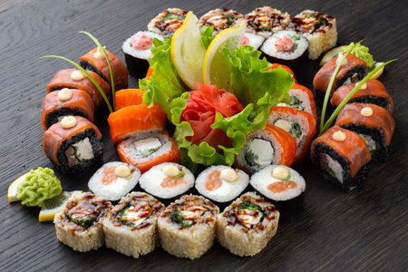 japanese sushi food. Maki ands rolls with tuna, salmon, shrimp, crab and avocado. Top view of assorted sushi. Rainbow sushi roll, uramaki, hosomaki and nigiri.の写真素材
