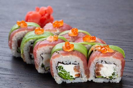 traditional Japanese sushi with salmon, avocado and soft cheese, garnished with red caviar. Japanese kitchen. Japanese restaurant.の写真素材