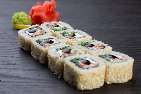 traditional Japanese sushi with eel, soft cheese and white sesame seeds, decorated with a drop of sauce. Japanese kitchen. Japanese restaurant.の写真素材