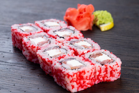 traditional Japanese sushi with salmon, avocado and soft cheese, garnished with red caviar. Japanese kitchen. Japanese restaurant.の写真素材