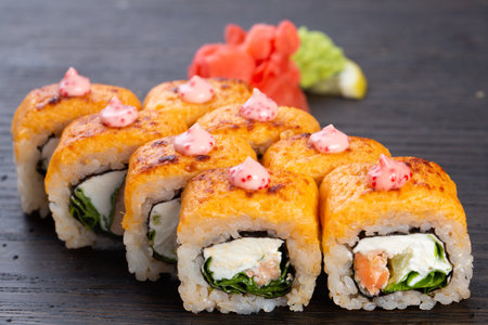 traditional baked Japanese sushi with salmon, avocado and soft cheese, garnished with sauce. Japanese kitchen. Japanese restaurant. warm sushiの写真素材