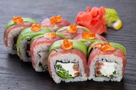 traditional Japanese sushi with salmon, avocado and soft cheese, garnished with red caviar. Japanese kitchen. Japanese restaurant.の写真素材