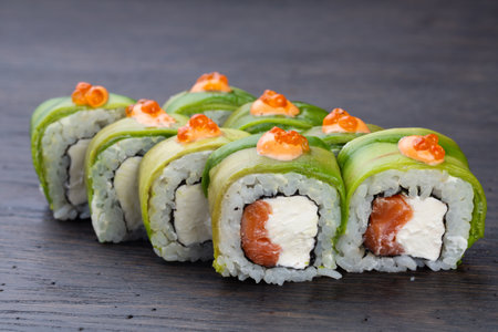 traditional Japanese sushi with salmon, avocado and soft cheese, garnished with red caviar. Japanese kitchen. Japanese restaurant.の写真素材