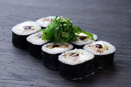 traditional Japanese sushi with tuna, soft cheese, avocado and seaweed, garnished with sauce. Japanese kitchen. Japanese restaurant.の写真素材